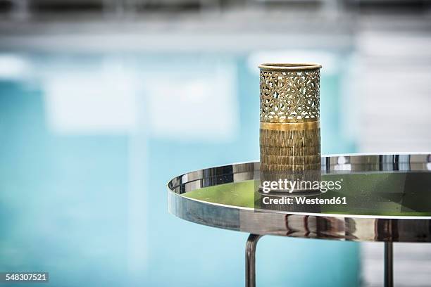 morocco, fes, hotel riad fes, tea light holder on side table near the pool - tavolino di servizio foto e immagini stock