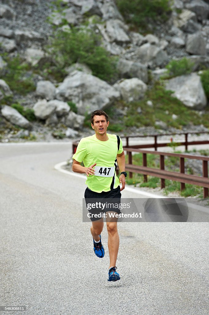 Italy, Trentino, man running in a competition near Lake Garda