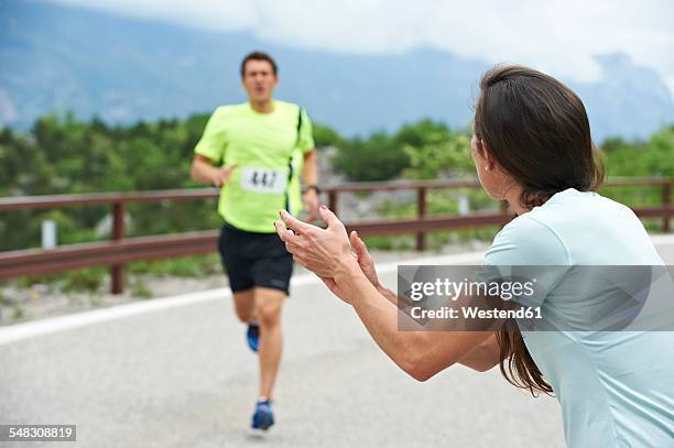 italy, trentino, woman rooting for runner in a competition near lake garda - coach cheering stock pictures, royalty-free photos & images