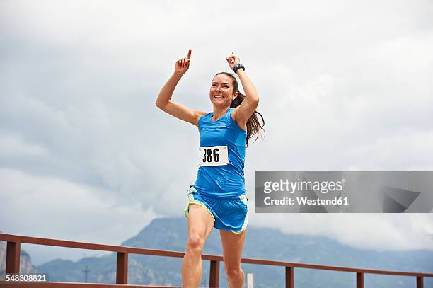 italy, trentino, woman winning a running competition near lake garda - running race stock pictures, royalty-free photos & images