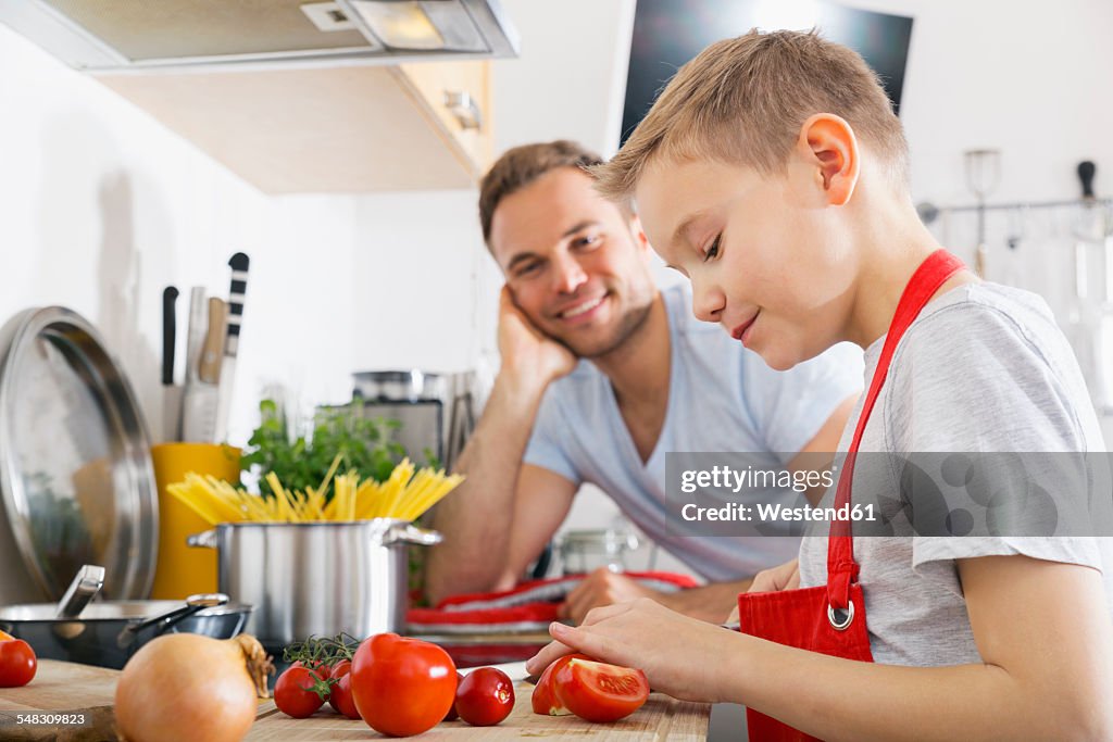 Father and son cooking together