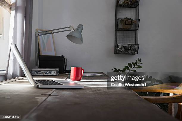 desk with laptop and coffee cup at home office - home office no people stock pictures, royalty-free photos & images