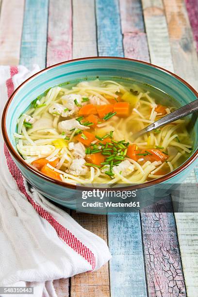 soup bowl of chicken stock with noodles, carrots and chive - chicken soup stock pictures, royalty-free photos & images