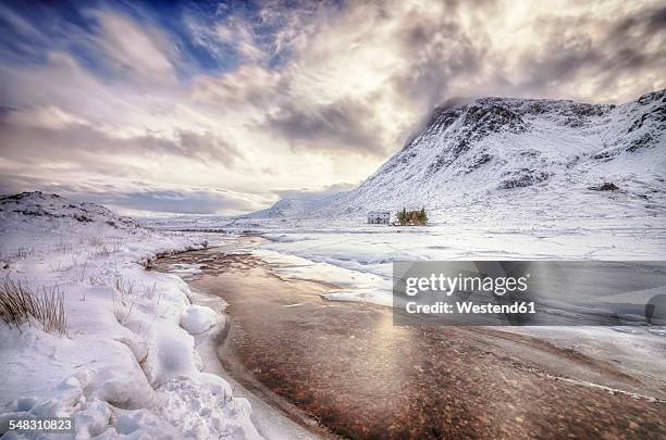 united kingdom, scotland, glencoe, solitude, house at river in winter - glencoe scotland stock pictures, royalty-free photos & images