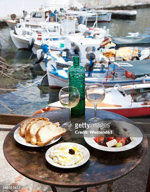greece, agios nikolaos, traditional greek starters and wine on table - greece food stock pictures, royalty-free photos & images