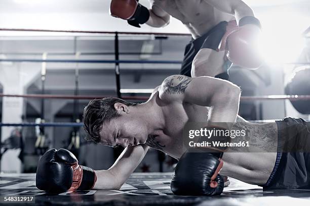 boxer knocking out his opponent - knocked down ストックフォトと画像