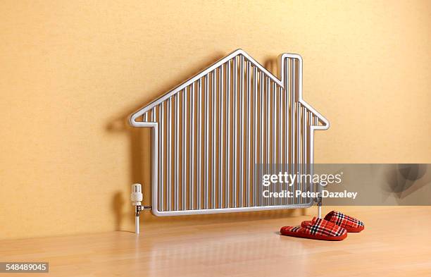 house shaped radiator with slippers - red house slippers stock pictures, royalty-free photos & images