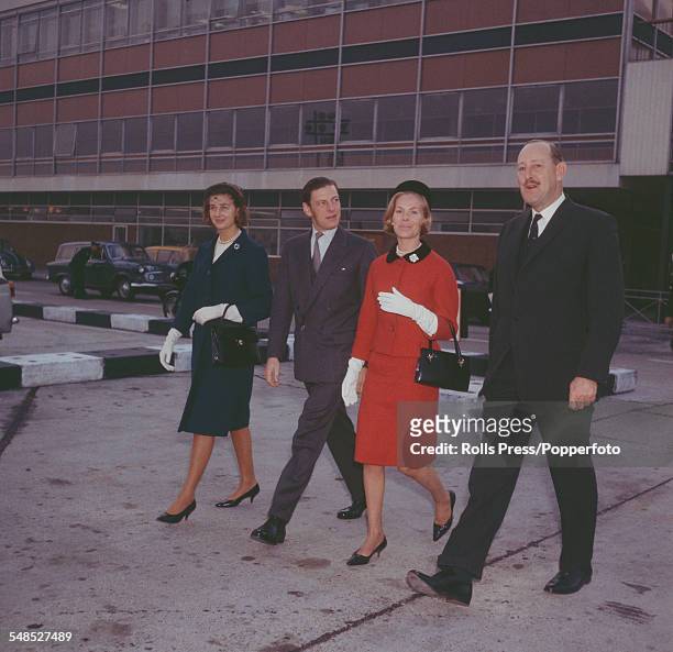Princess Alexandra, The Honourable Lady Ogilvy, Angus Ogilvy and Katharine, Duchess of Kent walk together with an unidentified man across the apron...