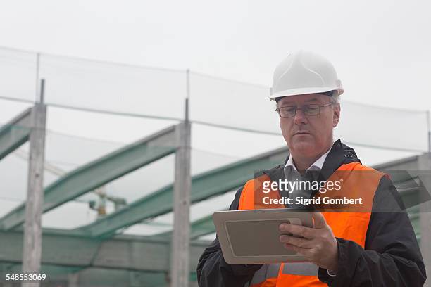 dock worker using digital tablet at port - basel port stock pictures, royalty-free photos & images