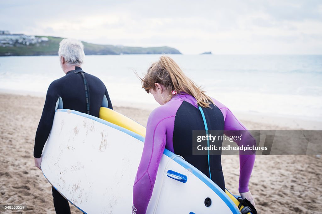 Couple with surfboard on beach