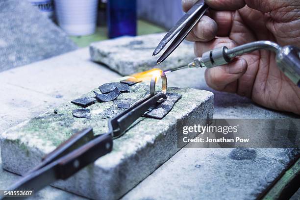 hands of jewellery craftsman using miniature blowtorch on platinum ring - jeweller tools stock pictures, royalty-free photos & images