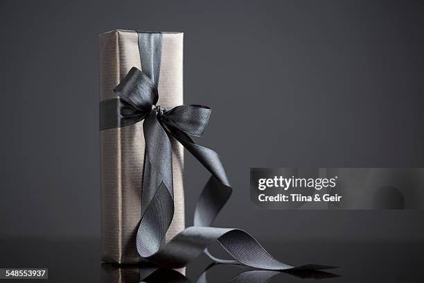 gift-wrapped boxes - black ribbon stock pictures, royalty-free photos & images