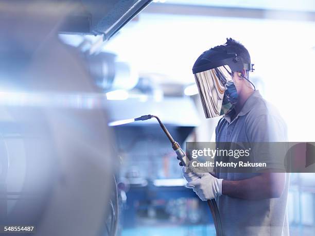 apprentice glass blower wearing mask and using lance - welding mask stock pictures, royalty-free photos & images