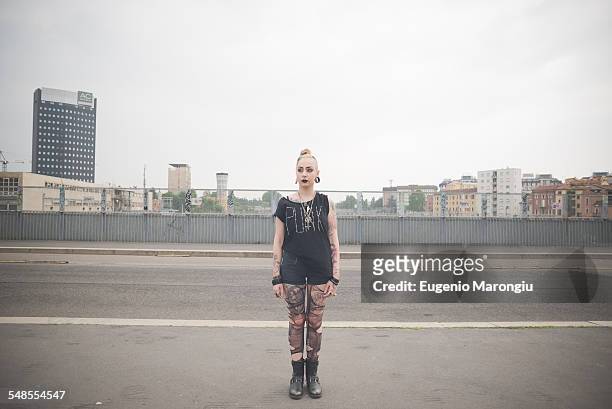 portrait of young female punk standing on city rooftop - punk stock-fotos und bilder