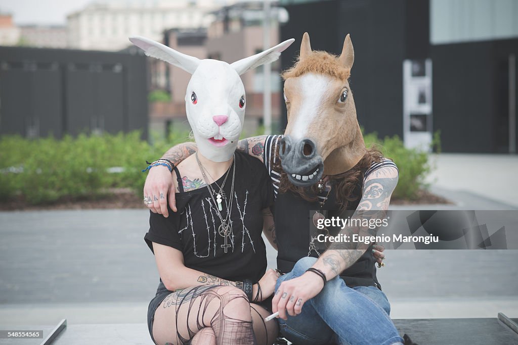 Portrait of punk hippy couple wearing rabbit and horse costume masks