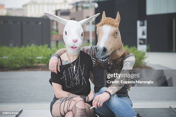 portrait of punk hippy couple wearing rabbit and horse costume masks - two animals ストックフォトと画像