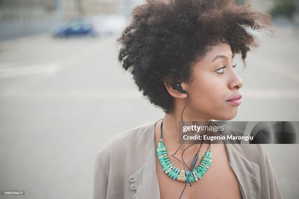 Portrait of young woman in city parking lot