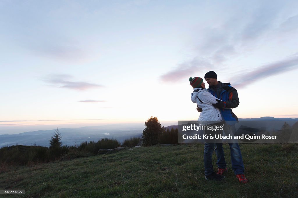 Couple hugging on hilltop, Montseny, Barcelona, Catalonia, Spain