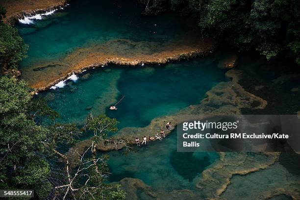 aerial view of tourists sunbathing on waterfall rock formations, semuc champey, alta verapaz, guatemala, central america - semuc champey stock pictures, royalty-free photos & images