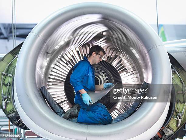 engineer holding jet engine turbine blade in aircraft maintenance factory - aerospace engineer ストックフォトと画像