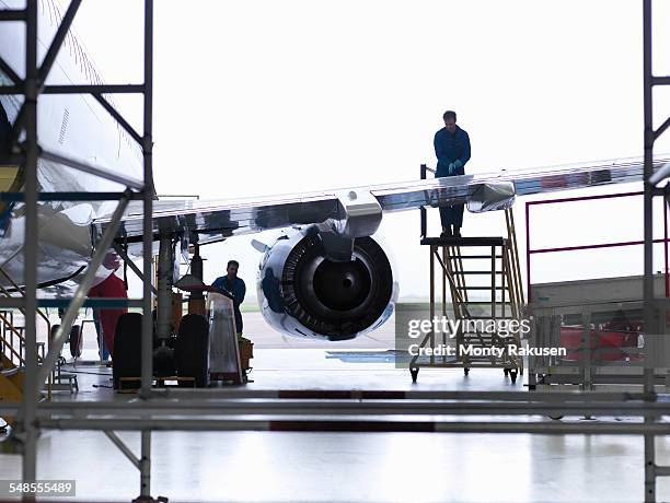 engineers working on aircraft wing in aircraft maintenance factory - aircraft maintenance stock-fotos und bilder