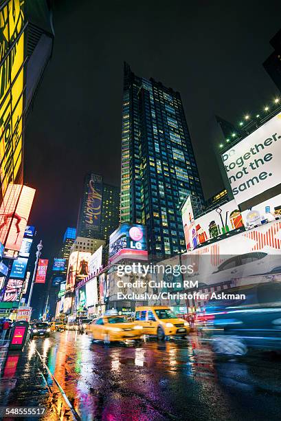 view of traffic and neon signs in times square at night, new york, usa - midtown manhattan stock pictures, royalty-free photos & images