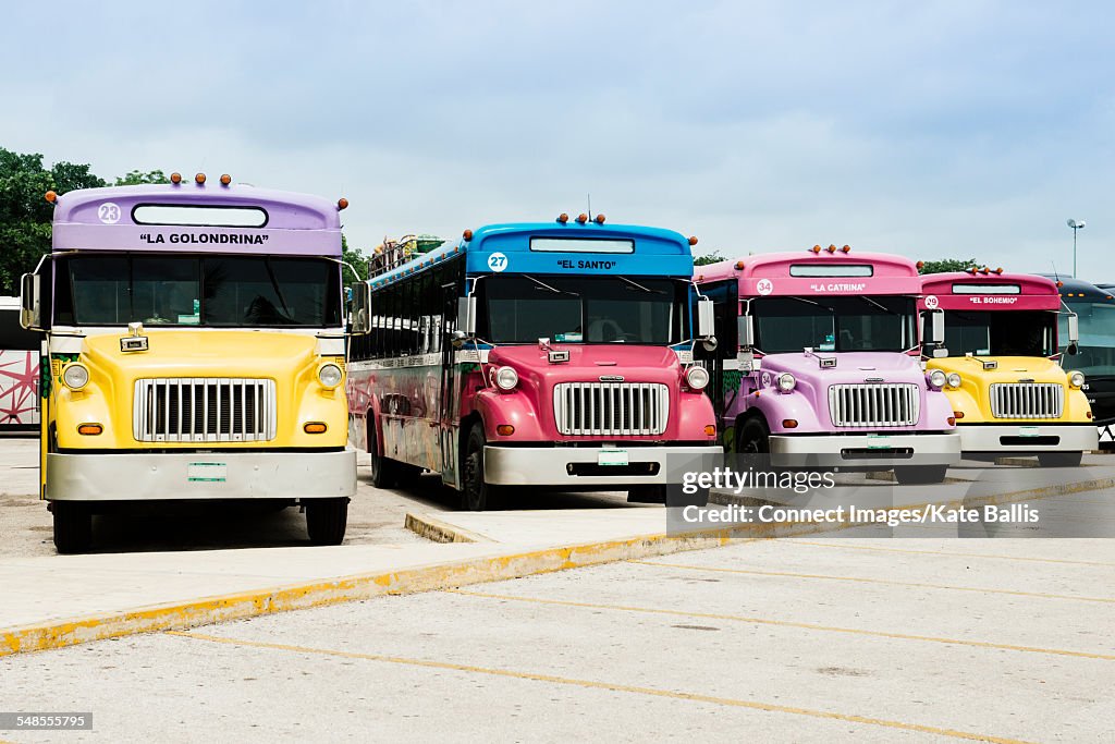 Parked, colourful buses, Tulum, Mexico