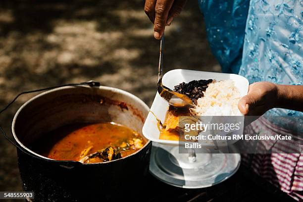 close up of stall holder serving food on tray, semuc champey, alta verapaz, guatemala, central america - semuc champey stock pictures, royalty-free photos & images