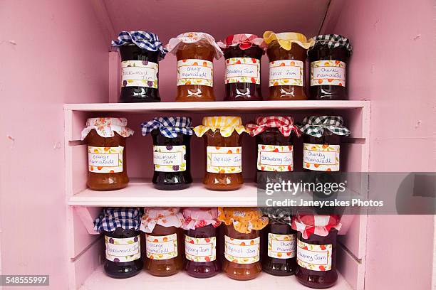 jars of homemade jam and marmalade on shop shelf - marmalade stockfoto's en -beelden