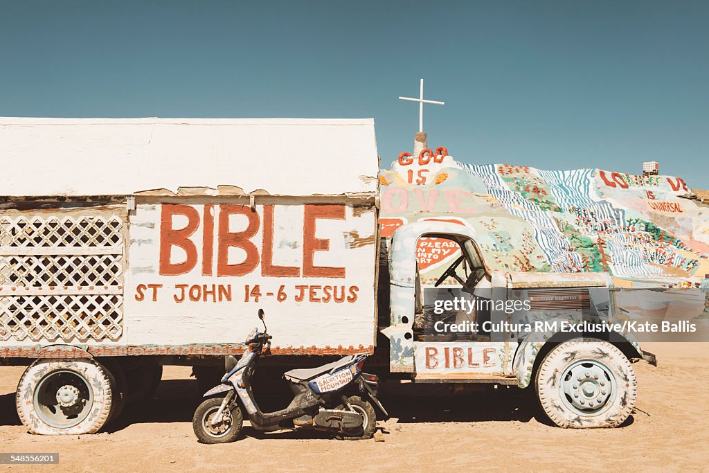 Painted words on abandoned truck in front of Salvation Mountain, Salton Sea, California, USA