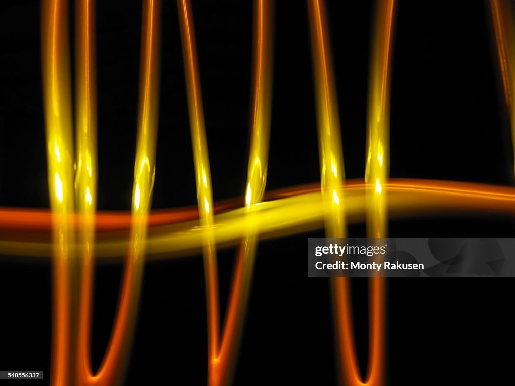 Abstract light trails made by molten metal against black background