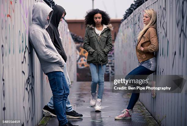 teenagers standing against wall with graffiti - lean to stock pictures, royalty-free photos & images