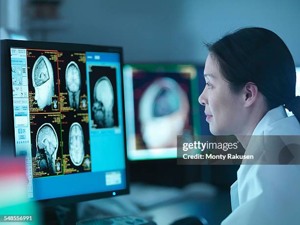 scientist looking at 3d rendered graphic scans from magnetic resonance imaging (mri) scanner, close up - scansione medica foto e immagini stock