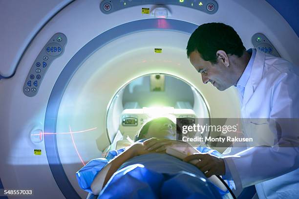 doctor and patient using magnetic resonance imaging (mri) scanner - röra mot bildbanksfoton och bilder