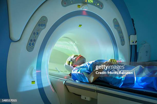 patient entering magnetic resonance imaging (mri) scanner - mri ストックフォトと画像