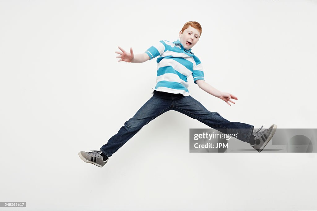 Boy jumping into midair