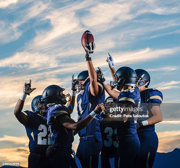 teenage and young male american football team celebrating together - american football player celebrating stock pictures, royalty-free photos & images