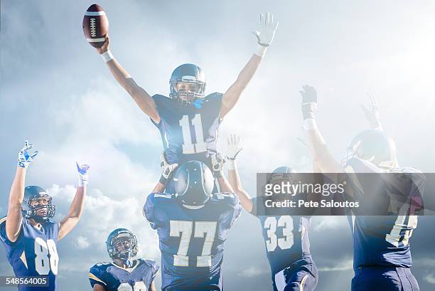 teenage and young male american football team celebrating on pitch - american football player celebrating stock pictures, royalty-free photos & images