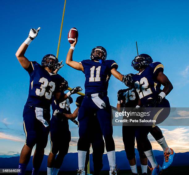 teenage and young male american football team celebrating - american football player celebrating stock pictures, royalty-free photos & images