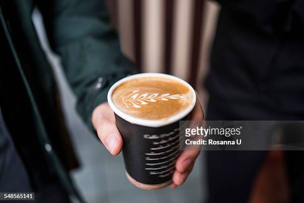 close up of male hand holding takeaway coffee - seattle coffee stock pictures, royalty-free photos & images