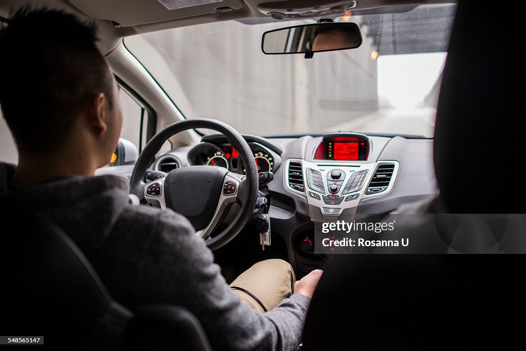 Rear view of young couple driving on city highway, Seattle, Washington State, USA