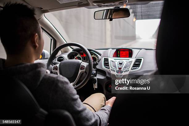 rear view of young couple driving on city highway, seattle, washington state, usa - asian couple car stockfoto's en -beelden