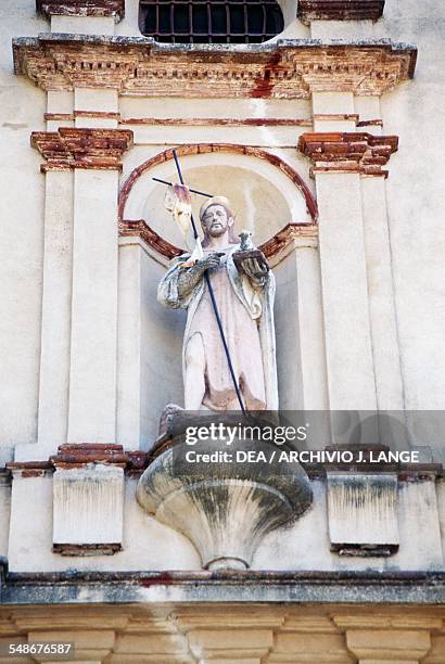 Statue of Christ the Good Shepherd on the facade of a church in Santa Ana de Real, Andalucia, Spain.