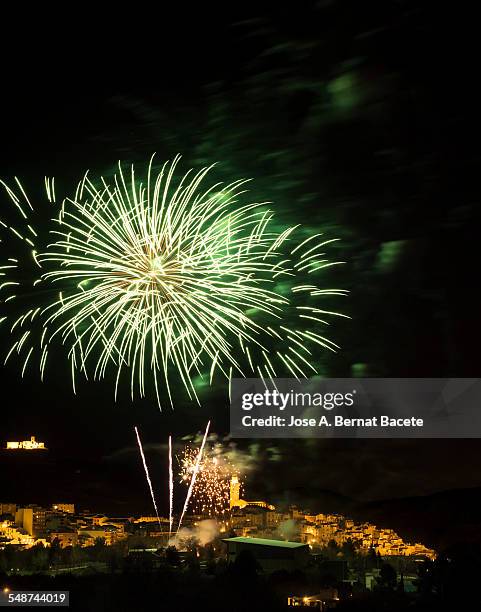 explosion of a firework over a small village - firework explosive material ストックフォトと画像