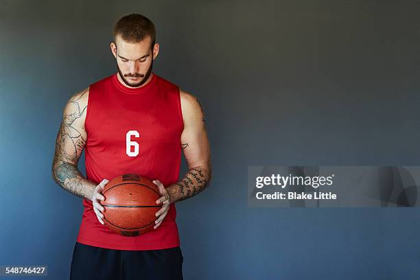 tattoo basketball player holding ball - man wearing sports jersey stock pictures, royalty-free photos & images