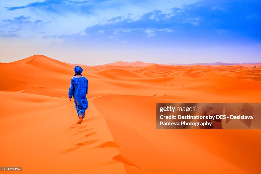A Berber walking in the desert