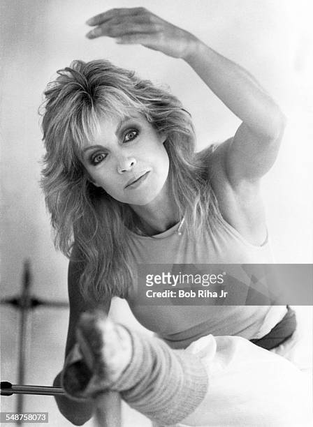 Portrait of American actress Donna Mills as she performs barre exercises in her home dance studio, Beverly Hills, California, March 18, 1983.