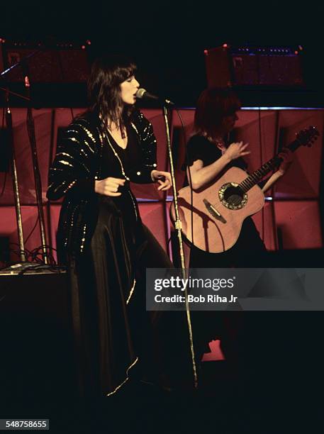 Sibling American musicians Ann and Nancy Wilson of the rock group Heart perform onstage at the Universal Amphitheatre, Los Angeles, California, July...