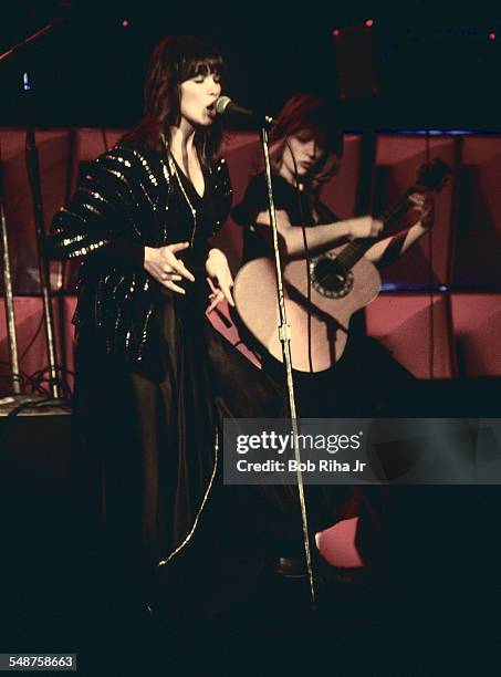 Sibling American musicians Ann and Nancy Wilson of the rock group Heart perform onstage at the Universal Amphitheatre, Los Angeles, California, July...