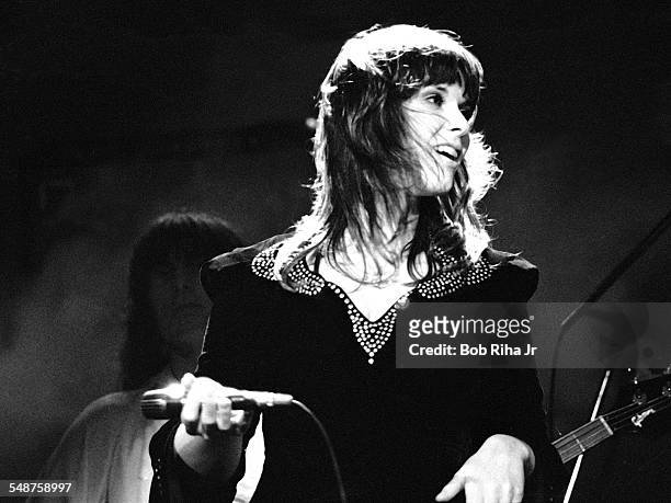 American musician Ann Wilson of the rock group Heart performs onstage at the Universal Amphitheatre, Los Angeles, California, July 15, 1977. Visible...